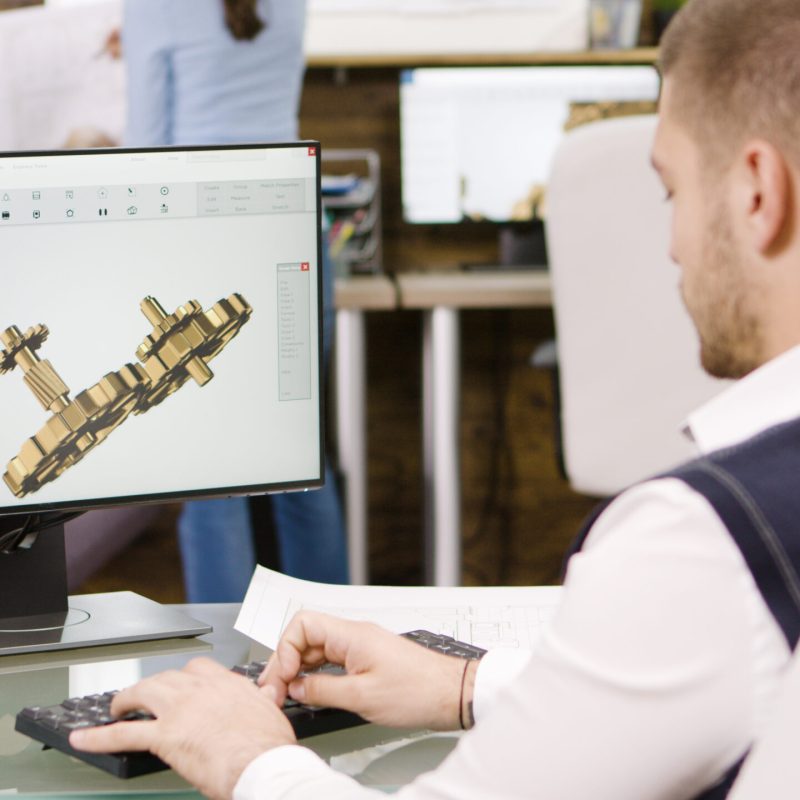 Bearded construction engineer working on his computer. Young entrepreneur.