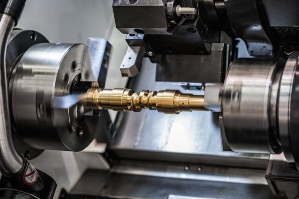 Metalworking CNC milling lathe machine. Cutting metal modern processing technology. Small depth of field. Warning - authentic shooting in challenging conditions. A little bit grain and maybe blurred.