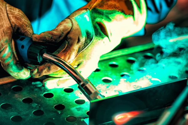 Welder with protective mask welding metal
